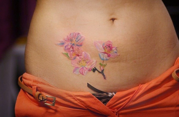 Tatuagem na barriga para meninas. Fotos, esboços de flores, inscrições, animais, padrões