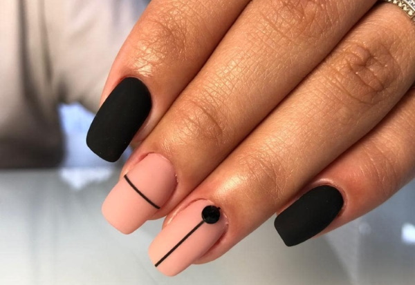 Bege com desenho de unhas pretas. Foto com um padrão, renda, fosco para unhas curtas